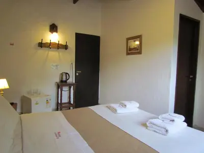 a bedroom with a bed with towels on it at La Posada de Akasha in Villa General Belgrano