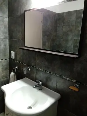 a bathroom with a white sink and a mirror at Casa Fleming in Villa Carlos Paz