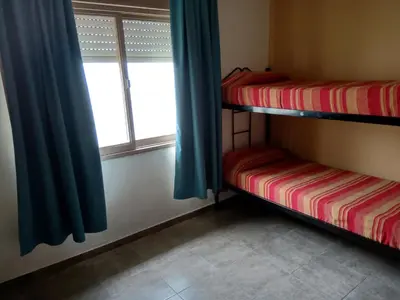 a room with two bunk beds and a window at Casa Fleming in Villa Carlos Paz