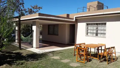 a table and chairs in front of a house at Casa Fleming in Villa Carlos Paz