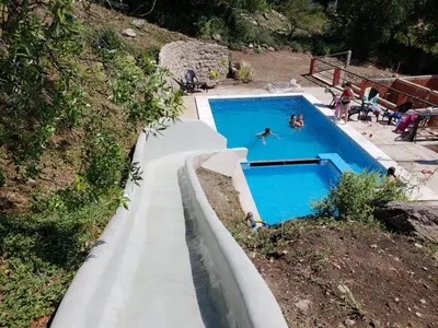 a swimming pool with people swimming in it at Balcon de los Molles in Santa Rosa de Calamuchita