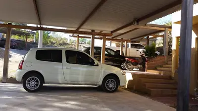a small white car parked under a garage at Balcon de los Molles in Santa Rosa de Calamuchita