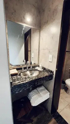 a bathroom with a sink and a mirror at Posada Piedramora in Mina Clavero