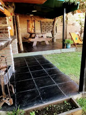 a patio with a picnic table in a backyard at complejo Casa Walter in Villa Carlos Paz