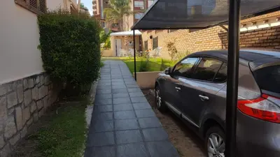 a car parked next to a sidewalk next to a building at complejo Casa Walter in Villa Carlos Paz