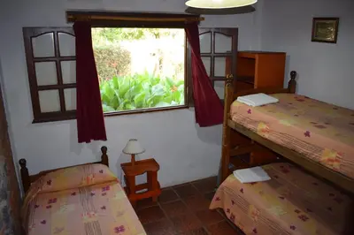 a bedroom with two bunk beds and a window at Cabañas La Rosada in Santa Rosa de Calamuchita