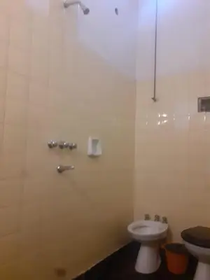 a bathroom with a toilet and a sink and a shower at El Viaje Hostel in Mina Clavero