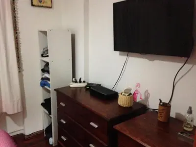 a bedroom with a wooden dresser and a dresser with a dresserngth at Departamento en Nueva Cordoba in Cordoba