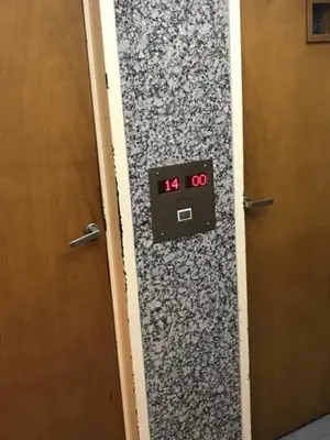 a clock on a wall next to a door at Departamento en Nueva Cordoba in Cordoba