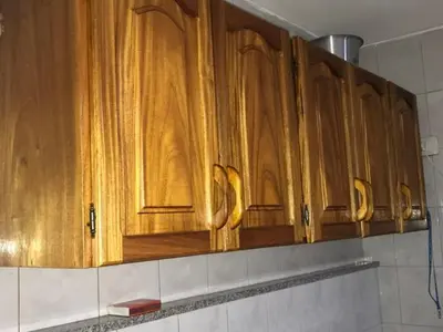 a row of wooden cabinets in a kitchen at Departamento en Nueva Cordoba in Cordoba