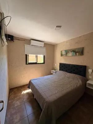 a bedroom with a large bed and a window at Los Frutales in Villa Carlos Paz