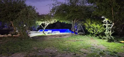a yard with a blue pool in the middle at Los Frutales in Villa Carlos Paz