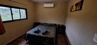a bedroom with a bed with blue pillows on it at Los Frutales in Villa Carlos Paz