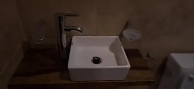 a bathroom with a white sink and a faucet at Los Frutales in Villa Carlos Paz