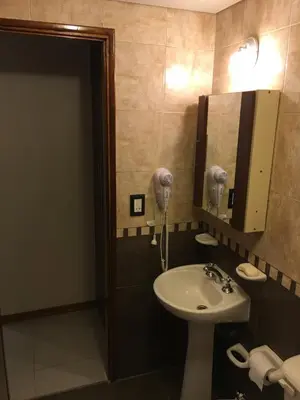 a bathroom with a sink and a mirror at Aires de la Villa in Villa Carlos Paz