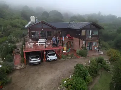 a man standing on the balcony of a house at Balcon Al Paradiso in Santa Rosa de Calamuchita