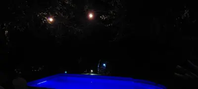 a blue swimming pool at night with lights at Balcon Al Paradiso in Santa Rosa de Calamuchita