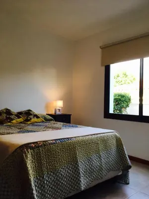 a bedroom with a bed and a window at La Carolina in Santa Rosa de Calamuchita