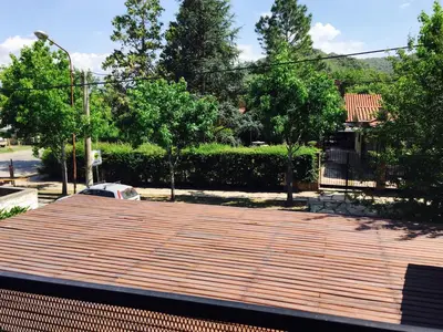 a wooden deck on top of a house at La Carolina in Santa Rosa de Calamuchita