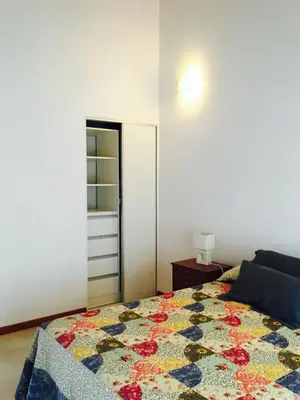 a bedroom with a bed with a quilt on it at La Carolina in Santa Rosa de Calamuchita