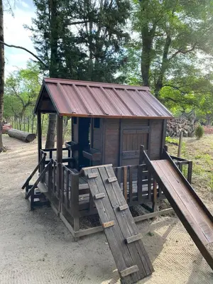 a small shack with a slide and a bench at Los Oleandros - casa privada in Nono