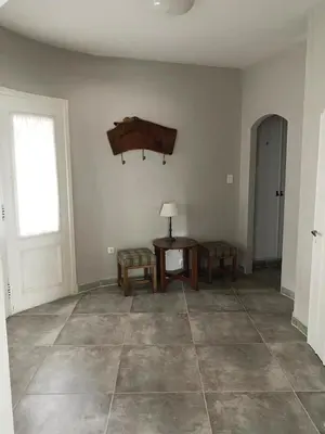 an empty living room with a table and a window at Los Oleandros - casa privada in Nono