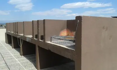 a pizza oven on the side of a building at Aires de la Villa II in Villa Carlos Paz
