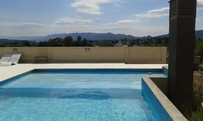 a swimming pool on the roof of a house at Aires de la Villa II in Villa Carlos Paz