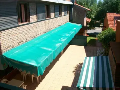 a group of blue tarp on a brick building at Hosteria Columbia in Mina Clavero