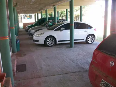 a white car parked in a parking garage at Hosteria Columbia in Mina Clavero