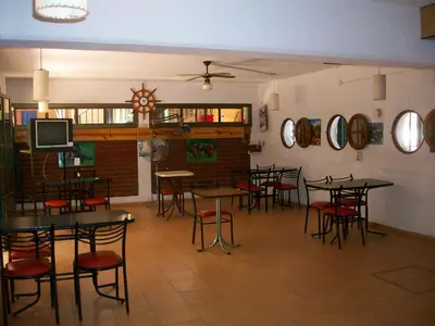 a restaurant with tables and chairs in a room at Hosteria Columbia in Mina Clavero
