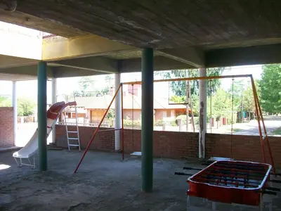 a play area with a slide and a playground at Hosteria Columbia in Mina Clavero