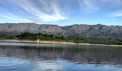 a large body of water with mountains in the background at Pasos Cortos Cabañas Nono in Nono