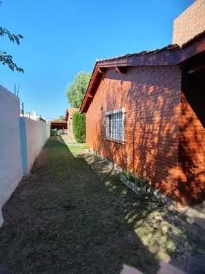 a brick building with a window on the side of it at El Aguaribay de los Nonos in Mina Clavero