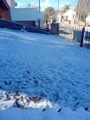a pile of snow on a driveway with a fence at El Aguaribay de los Nonos in Mina Clavero