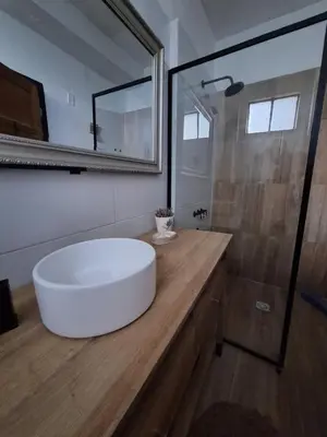a bathroom with a large white tub on a wooden counter at Posada Del Angel in Villa Serranita