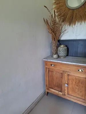 a wooden cabinet with a vase on top of it at Posada Del Angel in Villa Serranita