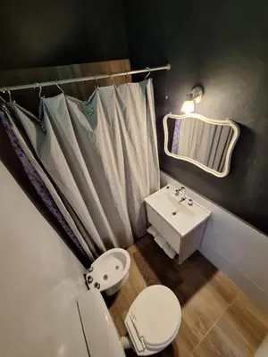 a bathroom with a toilet and a sink and a mirror at Posada Del Angel in Villa Serranita
