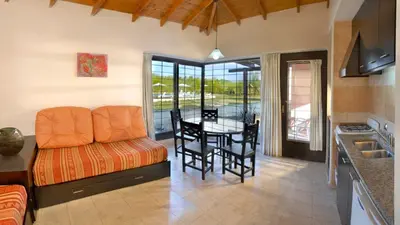 a kitchen and dining room with a table and chairs at Campiranas in Los Reartes