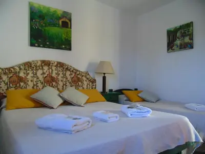 a bedroom with two beds with towels on them at Hosteria Aguas Claras in Mina Clavero