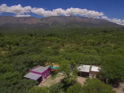 an aerial view of a house with mountains in the background at Entre Sierras y Pajaros in Las Rabonas