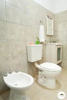 a bathroom with a toilet and a sink at Entre Sierras y Pajaros in Las Rabonas