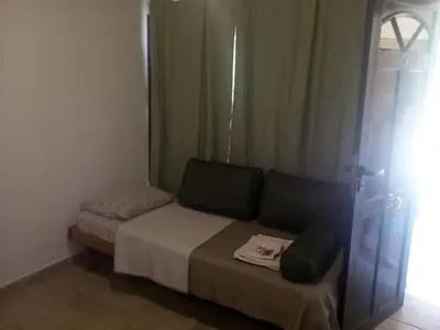a small bed in a room with a window at Cabañas Villa Bonita in Villa Ciudad Parque