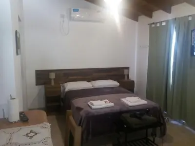 a bedroom with a bed with two towels on it at Cabañas Villa Bonita in Villa Ciudad Parque