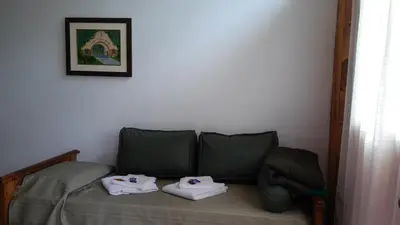 a bedroom with a bed with two towels on it at Cabañas Villa Bonita in Villa Ciudad Parque