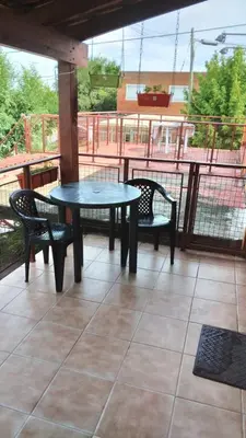 a table and two chairs on a patio at Lo de Lili Departamentos Mina Clavero in Mina Clavero