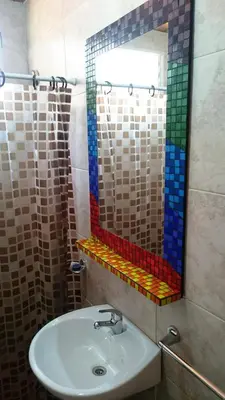 a bathroom with a sink and a mirror at Cabañas 57 in Villa Carlos Paz