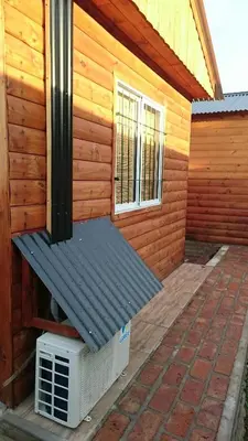 a house with a bench on the side of it at Cabañas 57 in Villa Carlos Paz