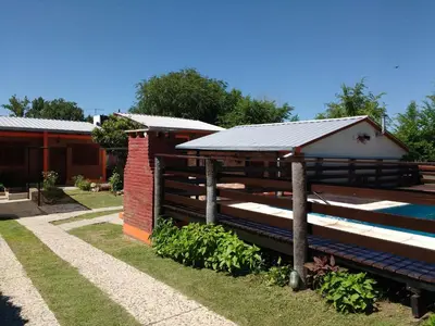 a house with a solar roof on the side of it at Cabañas mi Sueño in Villa Carlos Paz