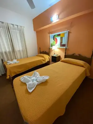 a hotel room with two beds with white bows on them at Hotel Los Aromos in Mina Clavero